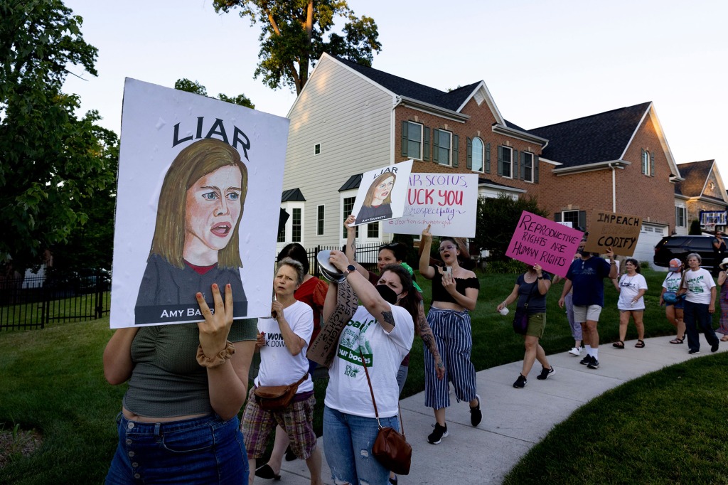Abortion rights activists march near the home of conservative Supreme Court Justice Amy Coney Barrett,